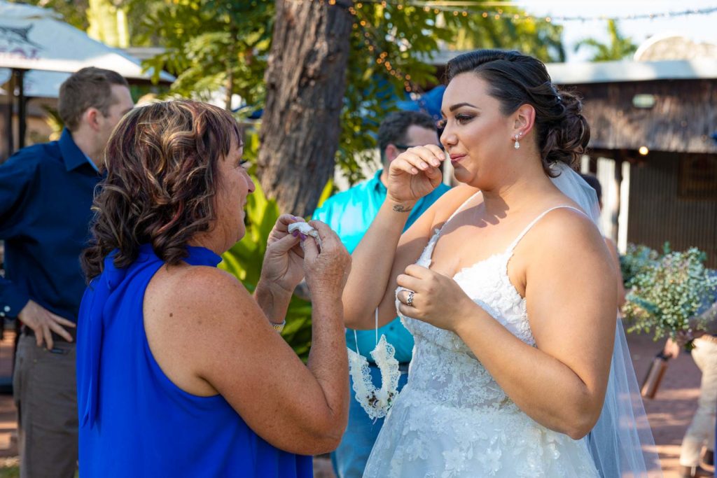 Bride and mother in law shed tears at wedding.