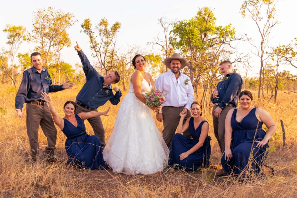 Bridal party in the outback doing a fun pose together.