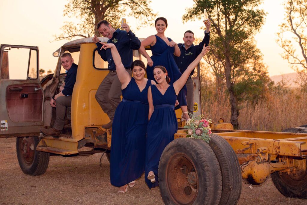 Bridesmaids and Groomsmen fun pose on a vintage truck.