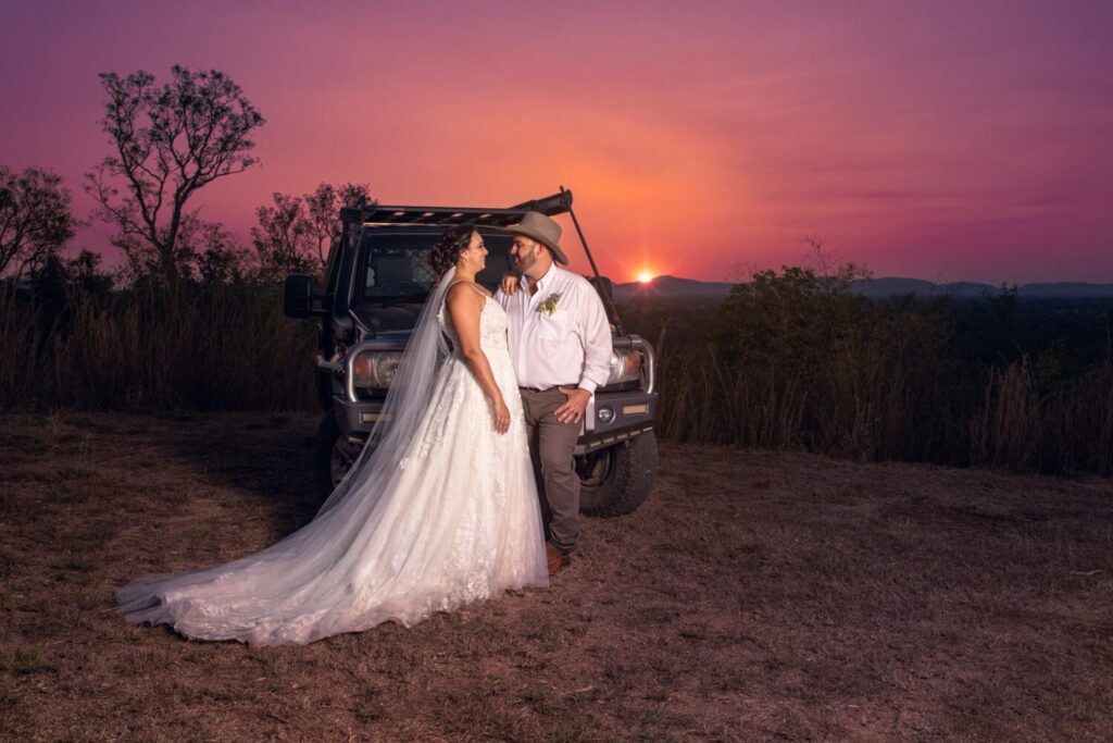 Wedding couple gaze at each other with a beautiful Top End sunset behind them.