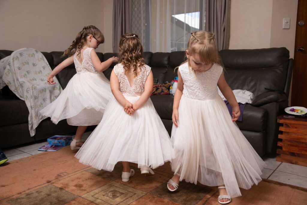 Three young bridemaids dance and twirl with excitement. Palmerston NT