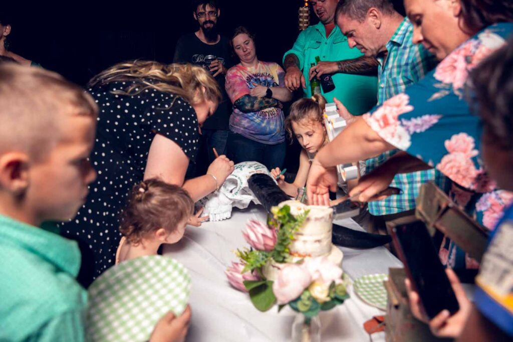 Wedding guests signing buffalo horns.