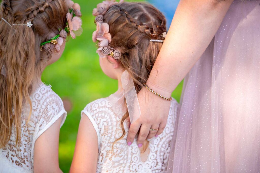 Close up of young bridesmaids&#039; hair decorations at Darwin wedding ceremony. Dudley Point NT.