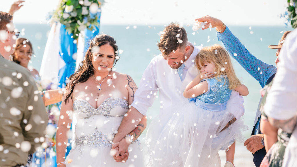 Fun Top End Wedding photograph. Couple  showered with confetti at Cullen Bay Darwin